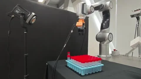 Robot inserting test tubes into a rack